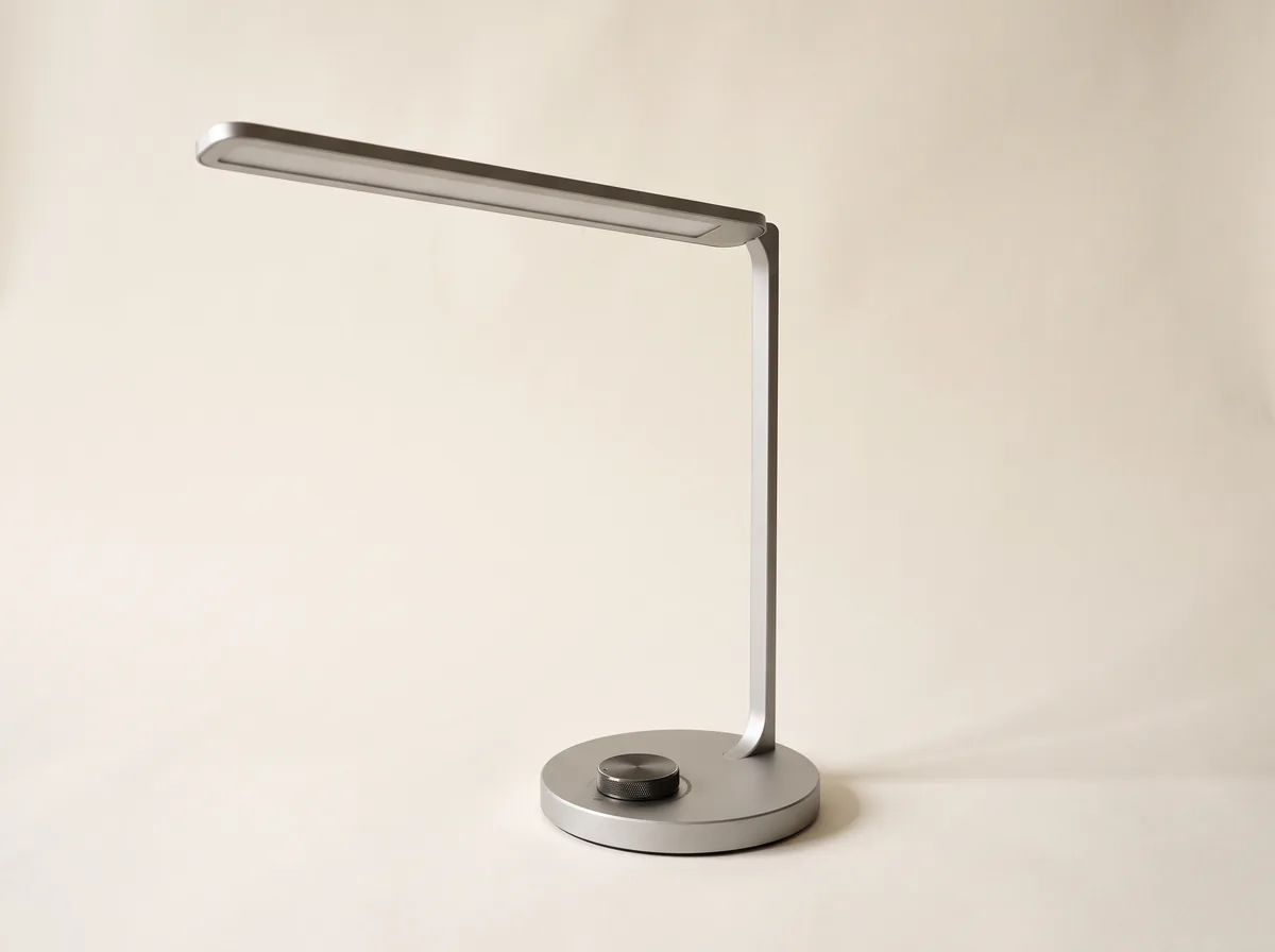 Schlanke Schreibtischleuchte mit langem waagerechtem LED-Kopf auf mattem Aluminiumfuß.